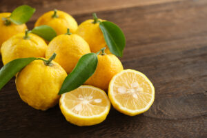 Yuzu fruit on wooden table - Edwin's Edibles